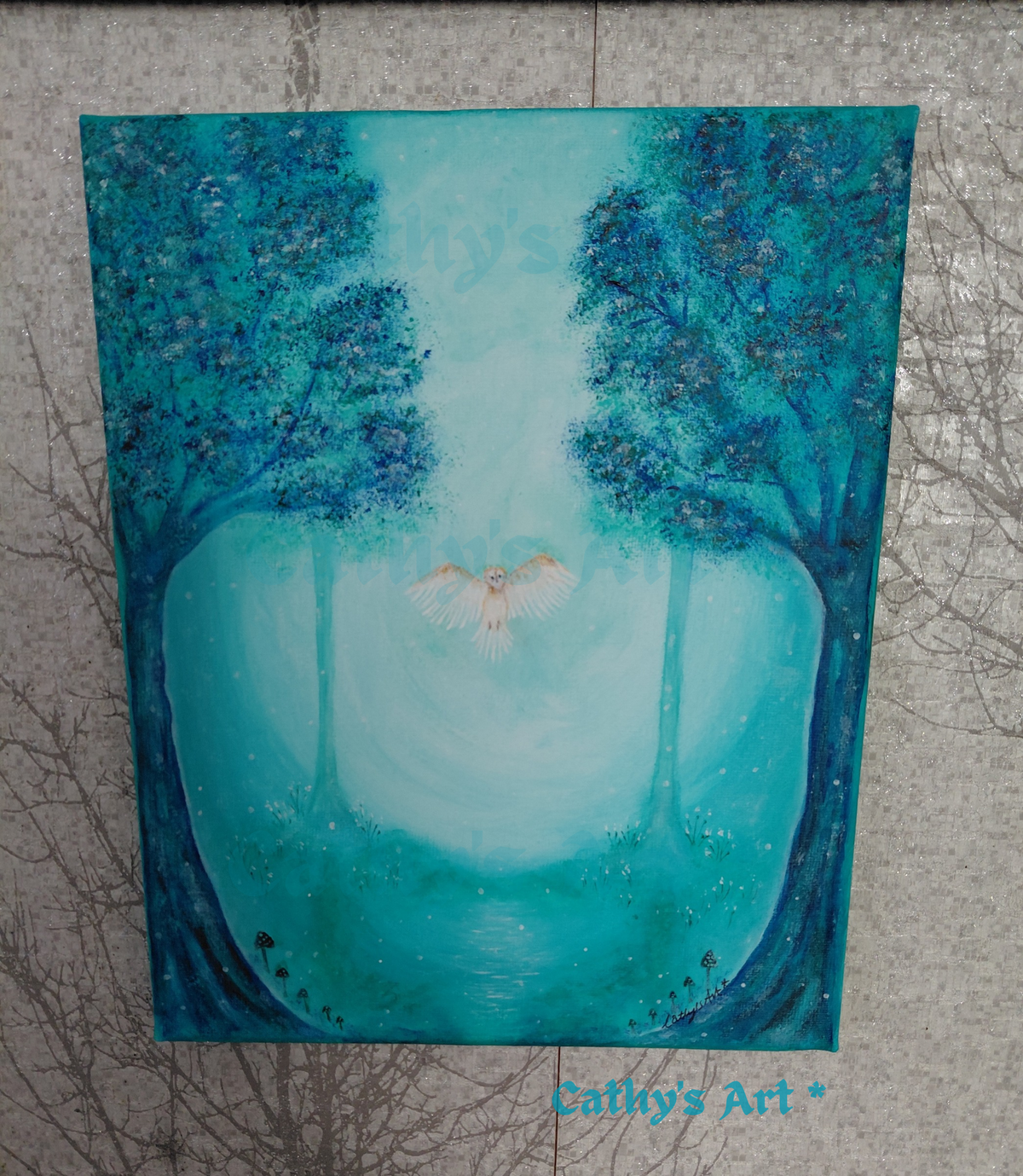 An original acrylic painting of a mystical forest scene, featuring two large trees with blue and turquoise foliage framing a glowing turquoise backdrop with a white flying owl. The painting is displayed on a textured grey background. Original acrylic canvas painting by Cathy's Art*
