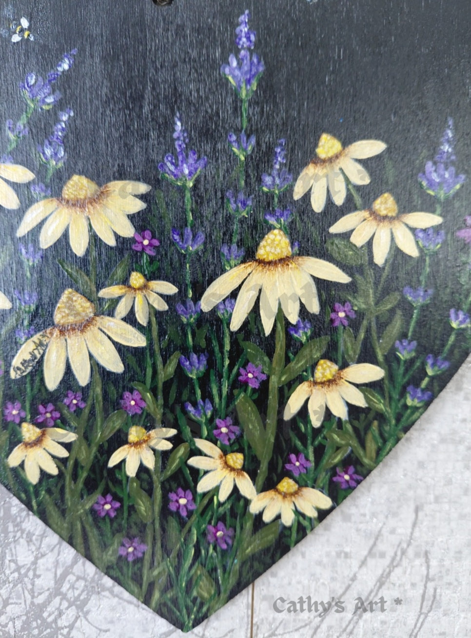 A close up of hand painted yellow daises, purple lavender and a tiny bee on a black background. Original acrylic painting on wooden heart plaque by Cathy's Art*