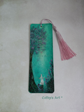A rectangular bookmark featuring a hand painted whimsical scene of a white rabbit under a glowing pink and green tree, with a pink tassel hanging from the top. The bookmark is displayed on a textured light background with the text 'Cathy's Art  *' printed below. Original hand painted bookmark by Cathy's Art*