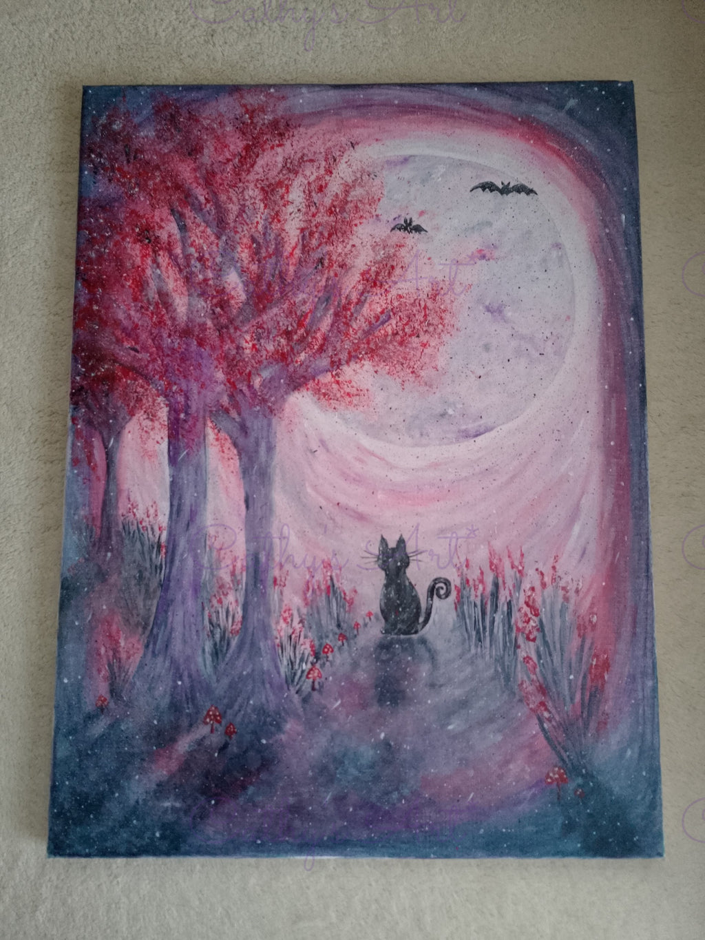 A whimsical fantasy painting of a black cat sitting under a large tree with vibrant red foliage, set in a misty purple and pink landscape with bats flying in the sky. On a cream background. Original canvas painting by Cathy's Art*