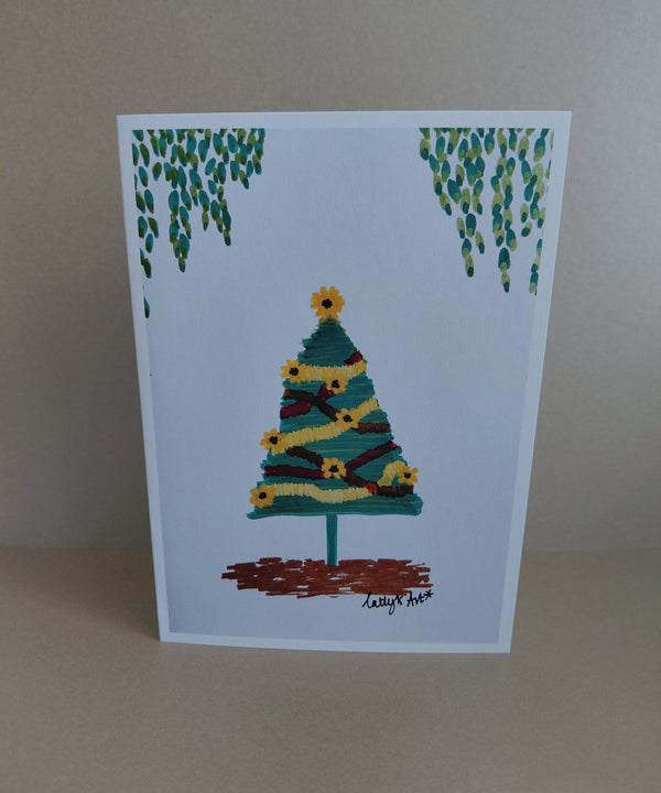 A printed artwork Christmas Card with a sunflower Christmas tree with sunflowers and tinsel. Leavy foliage hangs above the tree. Original artwork & printed by Cathy's Art*